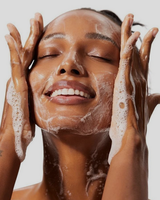 Woman washing her face.
