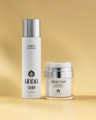 Hrda Skin Clarity Cleanser and Cohesion Moisturizer on a gold background