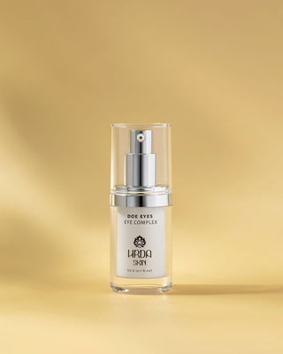 Skincare serum bottle labeled 'Hrda Skin' Doe Eyes Eye Complex on a gold background